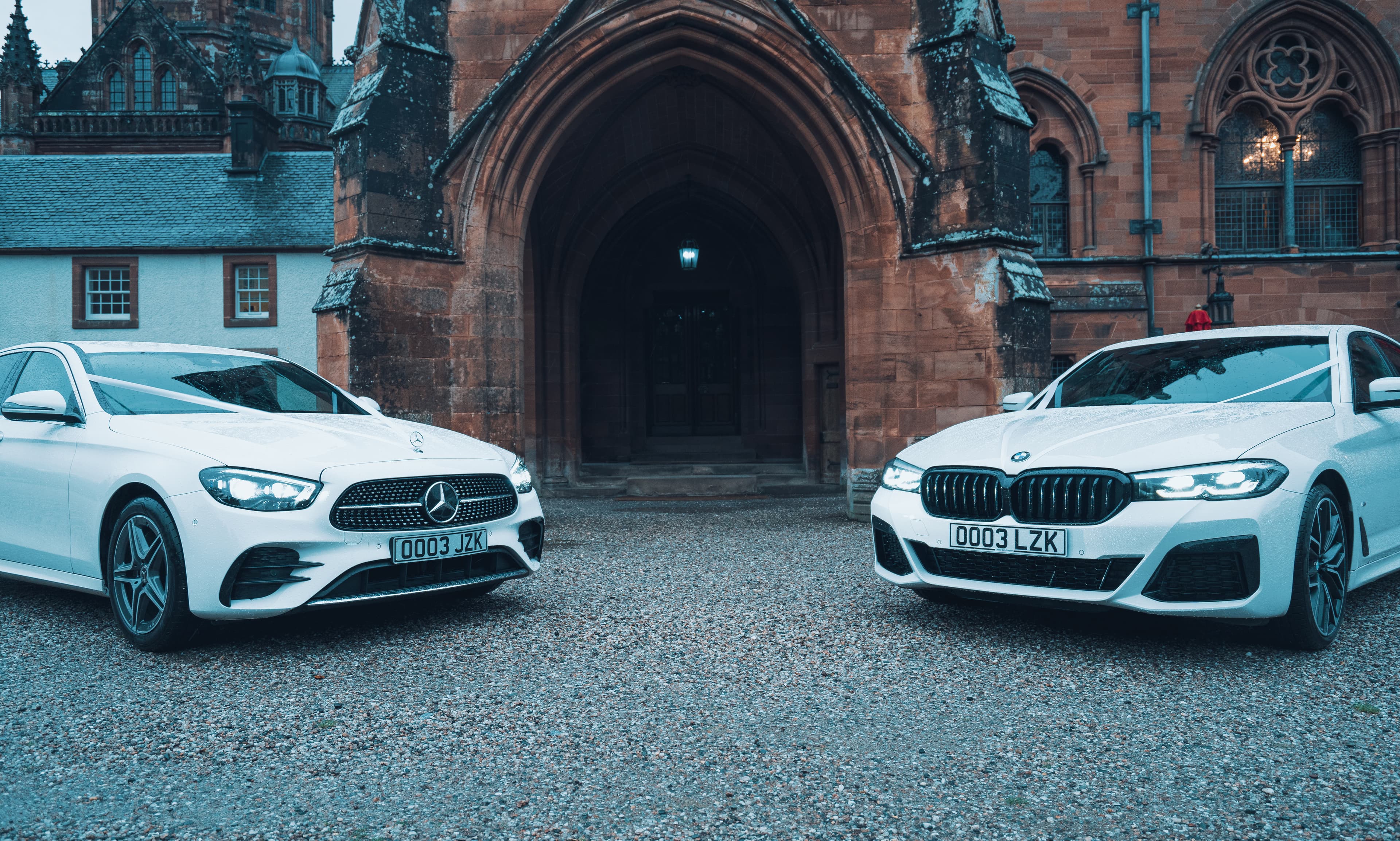Mercedes and BMW through archway